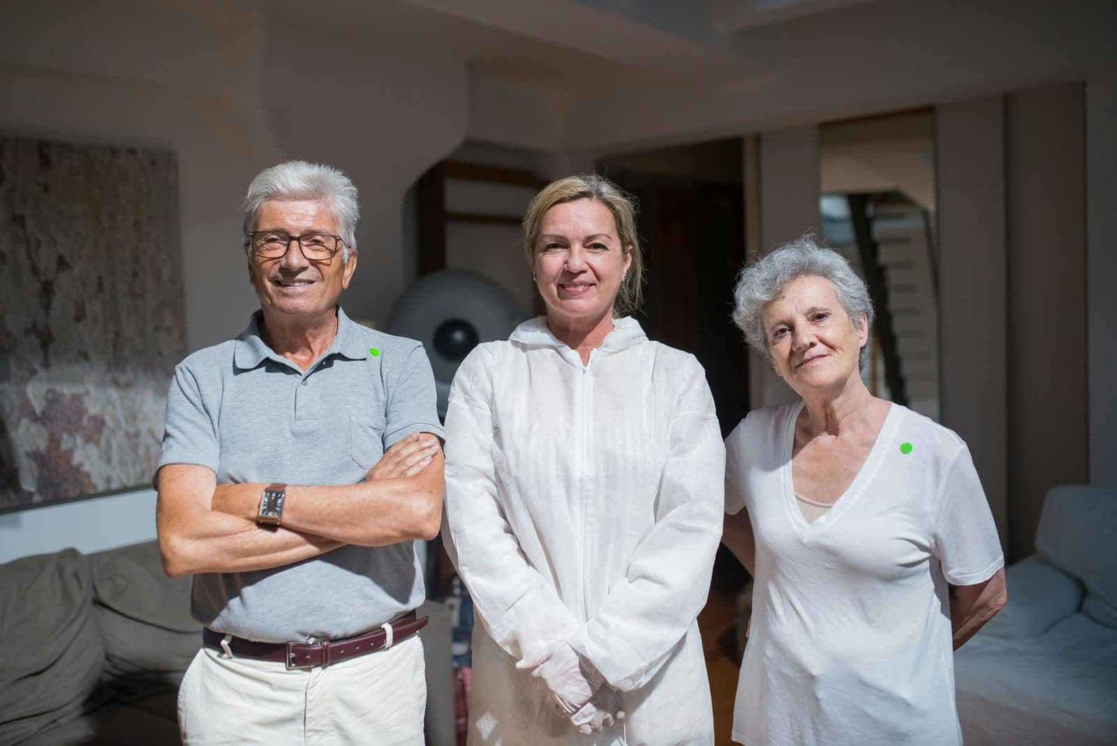 Three adult family members standing next to each other and smiling
