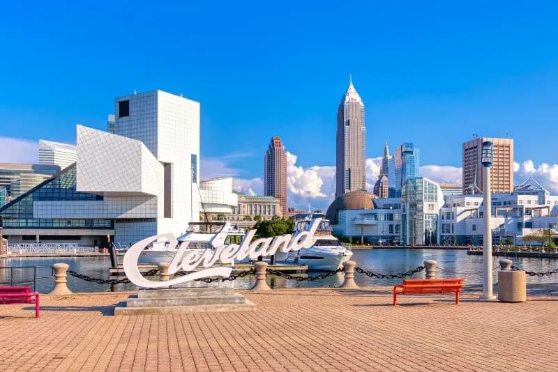 Image of a Cleveland sign on a dock with Cleveland skyline in the background