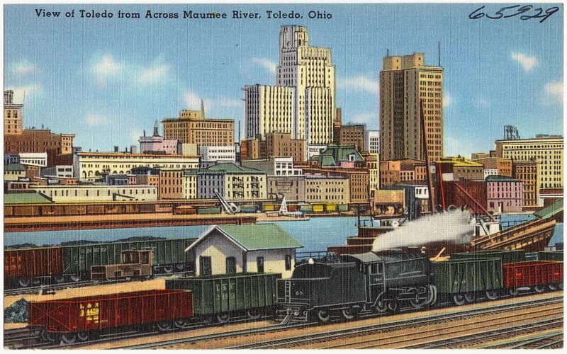 A vintage image of Toledo with a train and city skyline in the background
