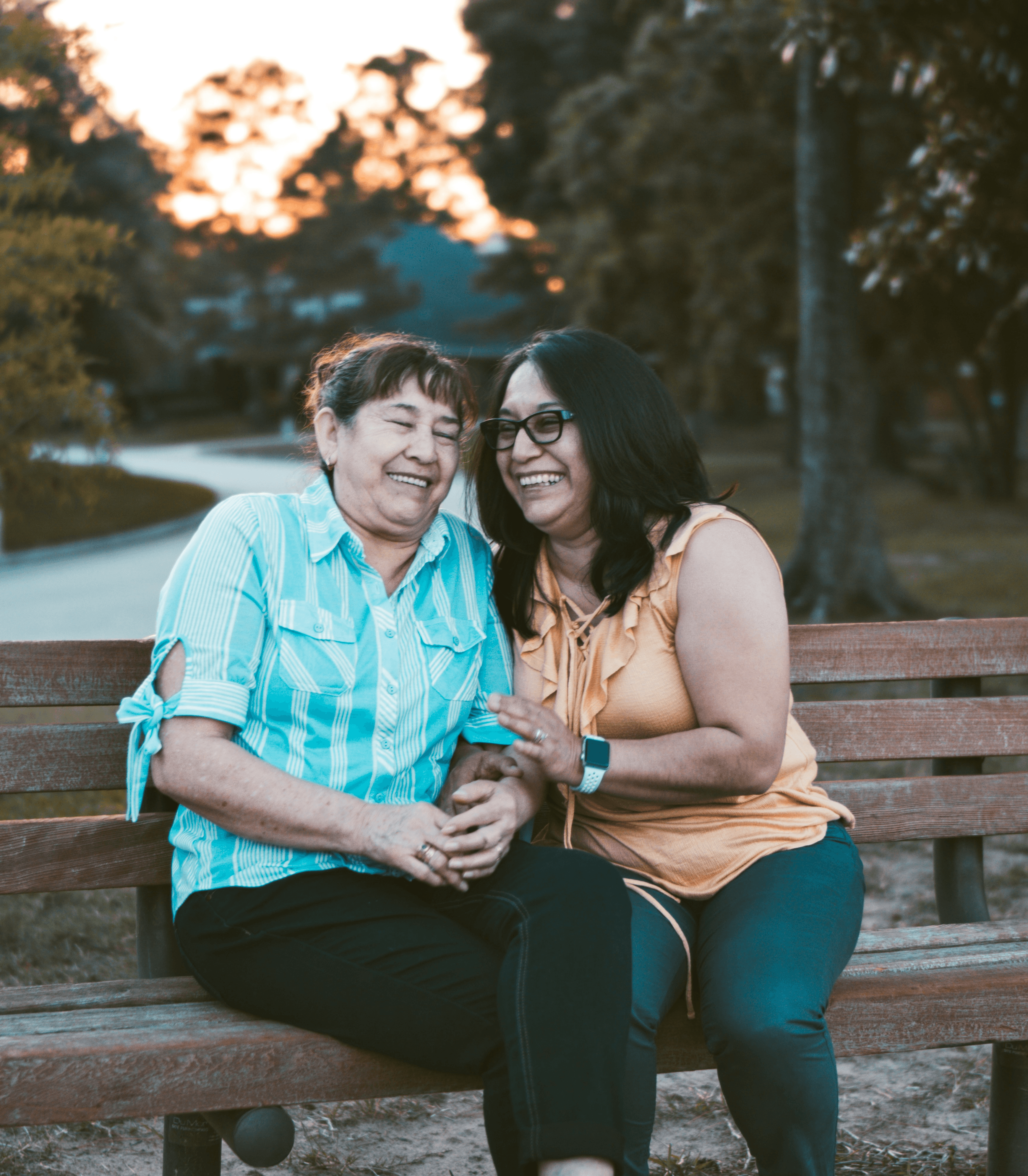 A mom and daughter sharing a meaningful moment at a park bench